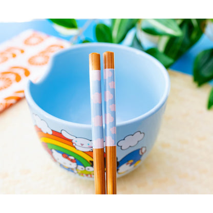 Close-up of bamboo chopsticks with pastel pink cloud designs resting on blue ceramic bowl featuring Sanrio characters
