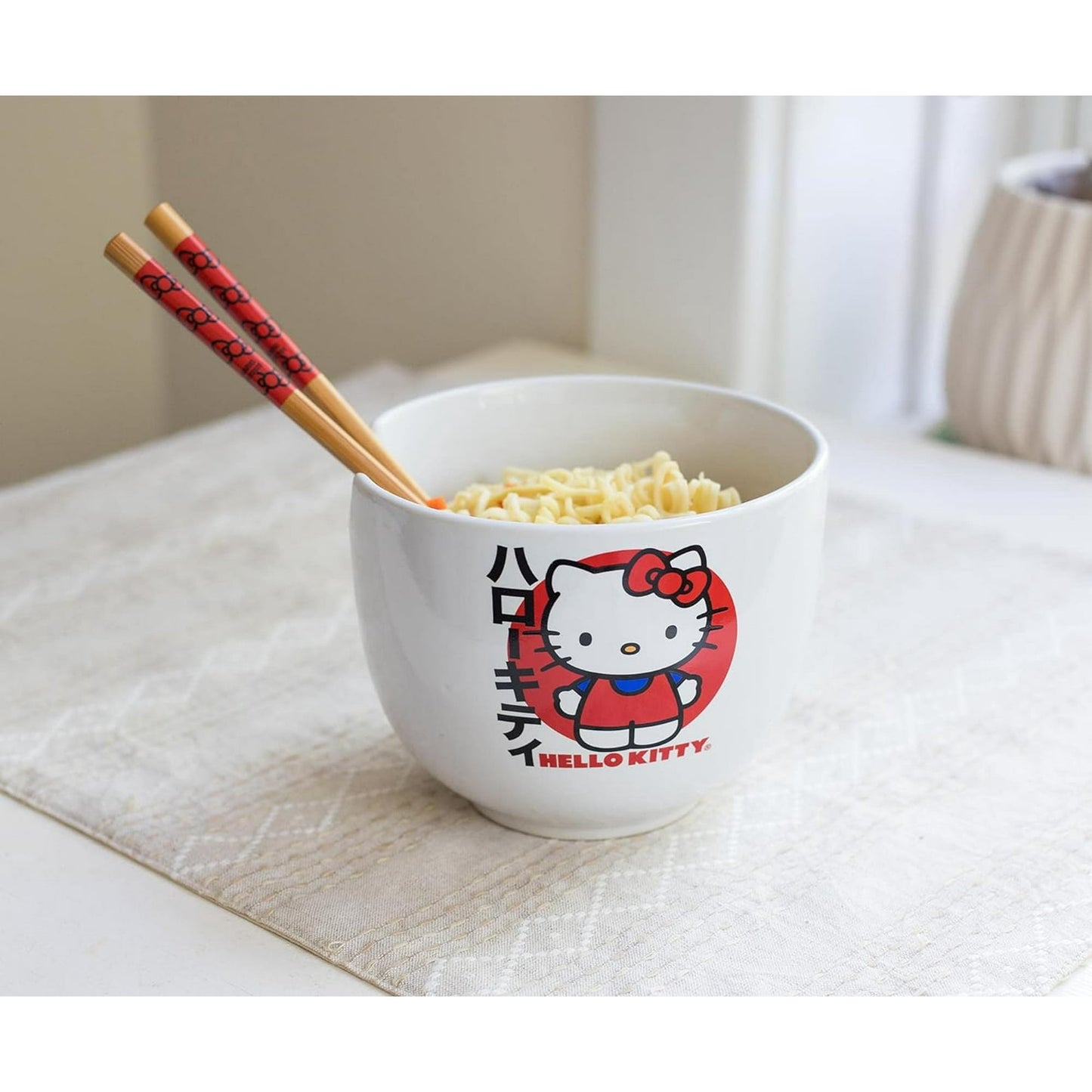 Top view of Hello Kitty ceramic ramen bowl with bamboo chopsticks resting on the notch