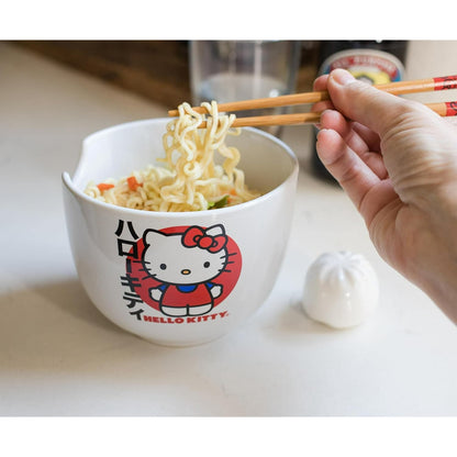 Hello Kitty ramen bowl with chopsticks placed inside on a table with a beige placemat