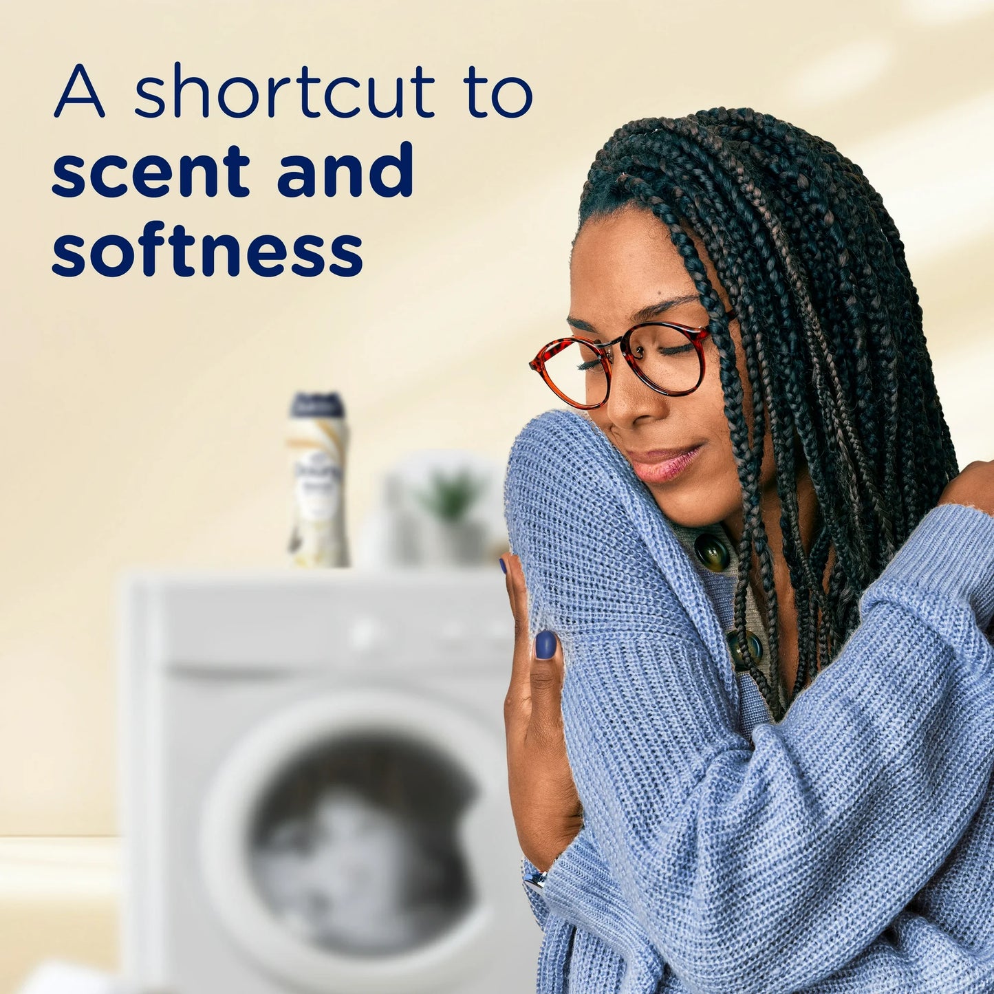 Two hands holding Downy Blends fabric softener with warm vanilla scent label  